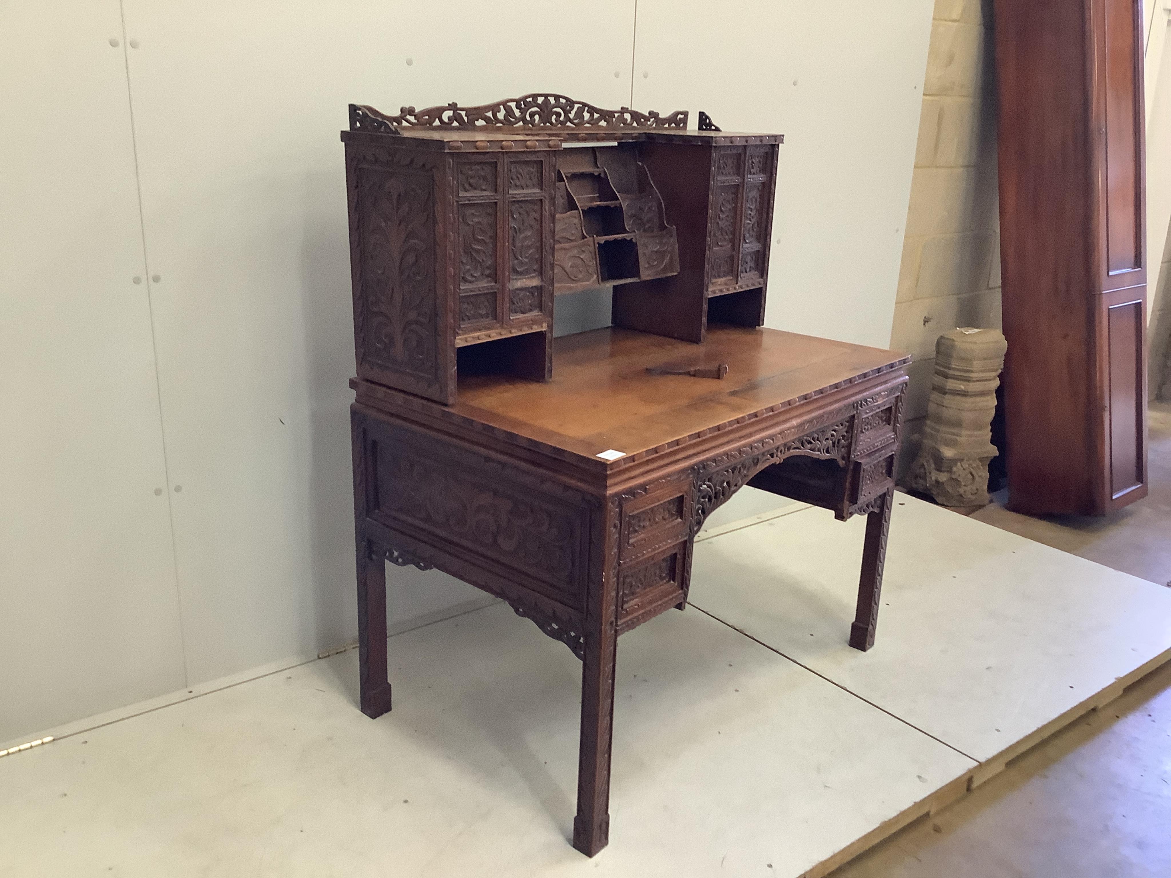 A late 19th century Chinese export carved hardwood kneehole writing desk, width 107cm, depth 66cm, height 120cm